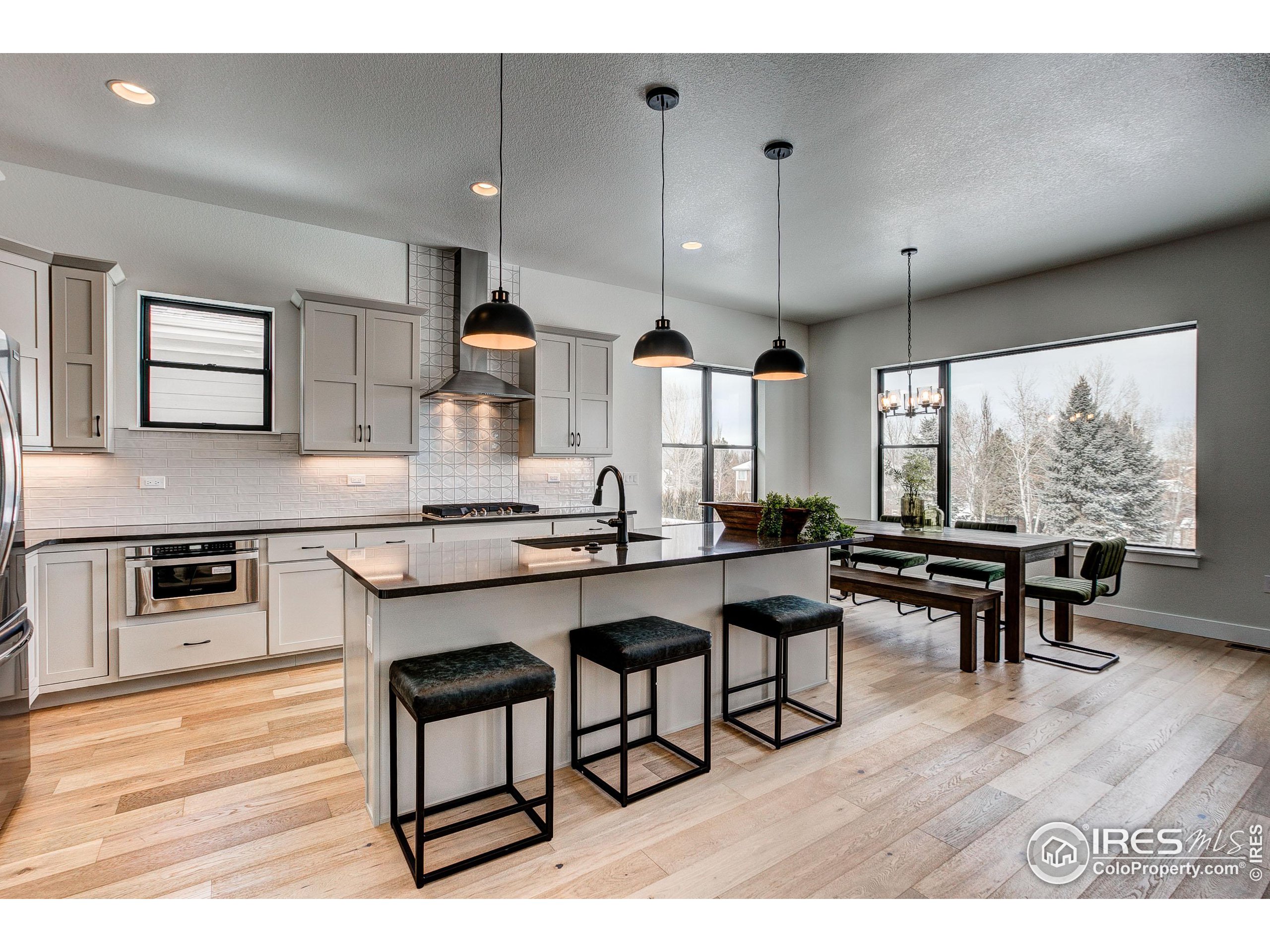 a large kitchen with a table and chairs