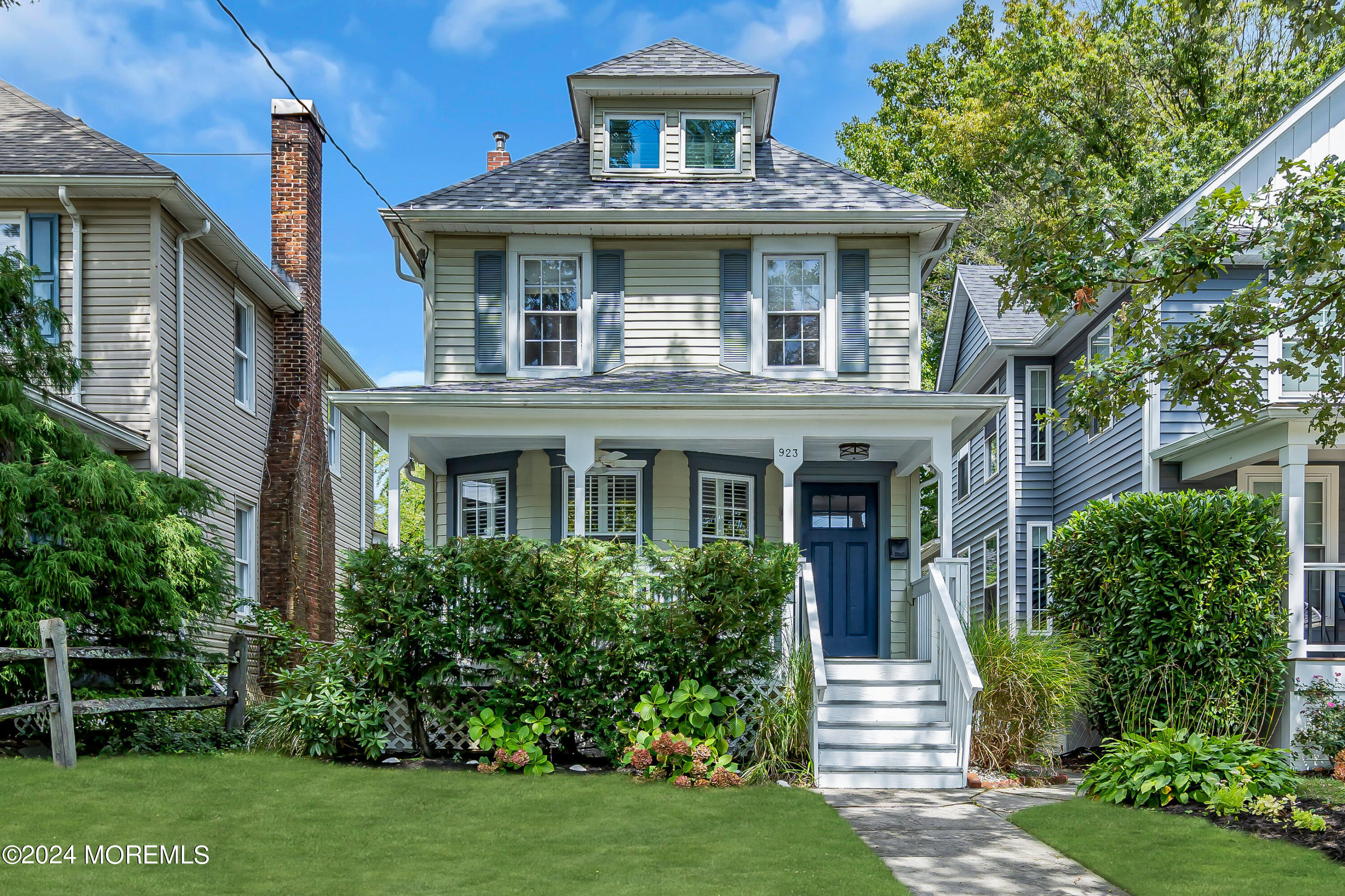 a front view of a house with a garden