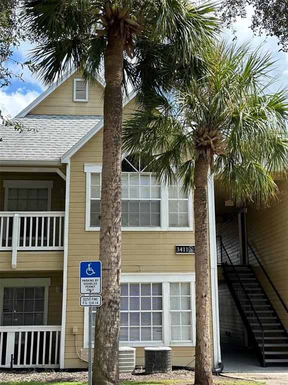 a front view of a house with a tree