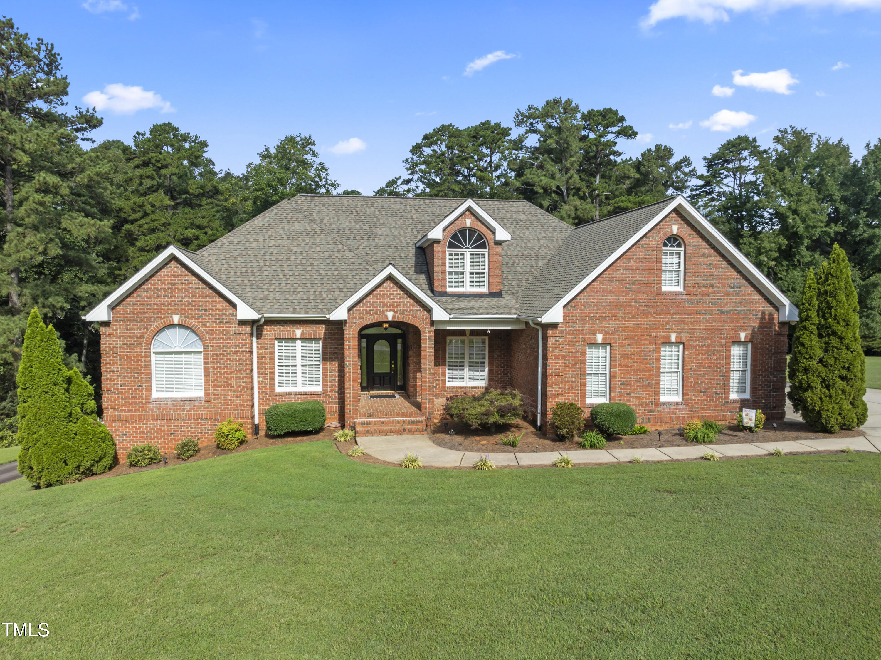 a front view of house with yard and green space