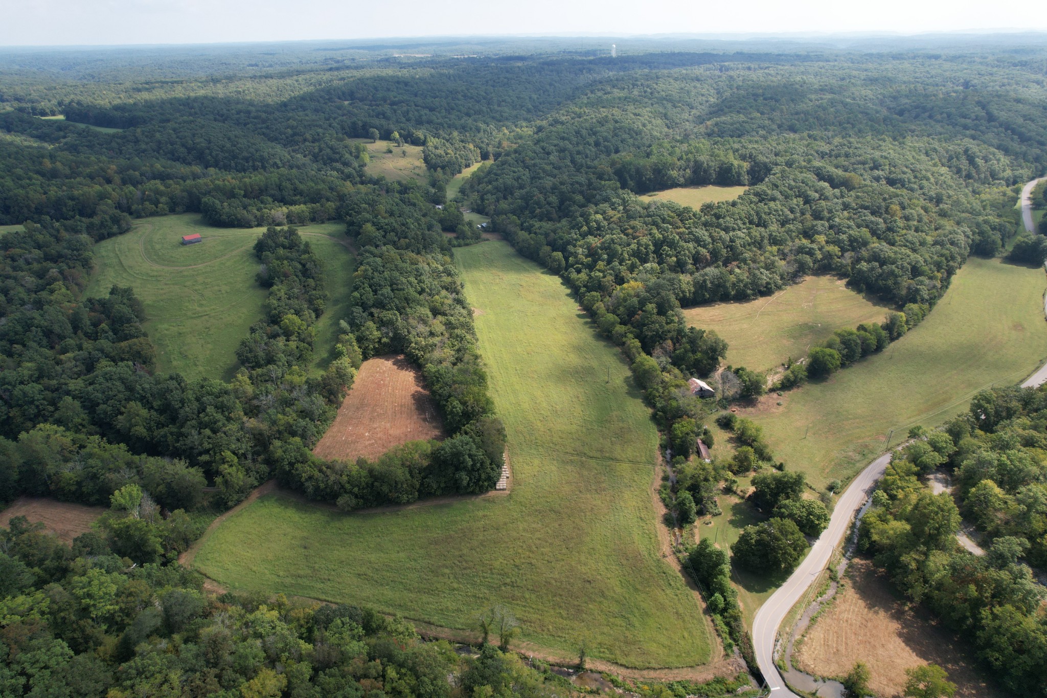 an aerial view of a house with a yard and lake view