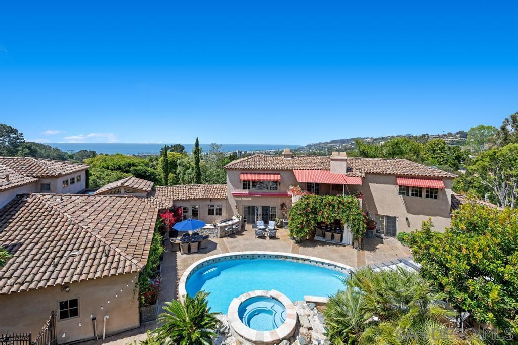 an aerial view of a house with swimming pool and lake view