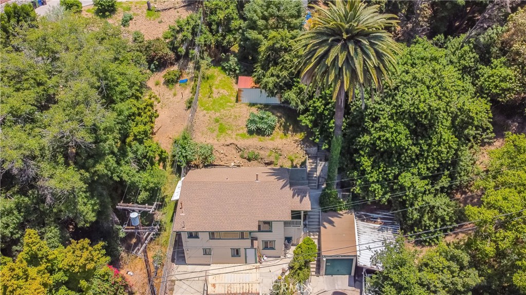 an aerial view of a house with yard swimming pool and outdoor seating