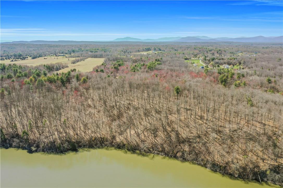 Birds eye view of property with a water and mountain view