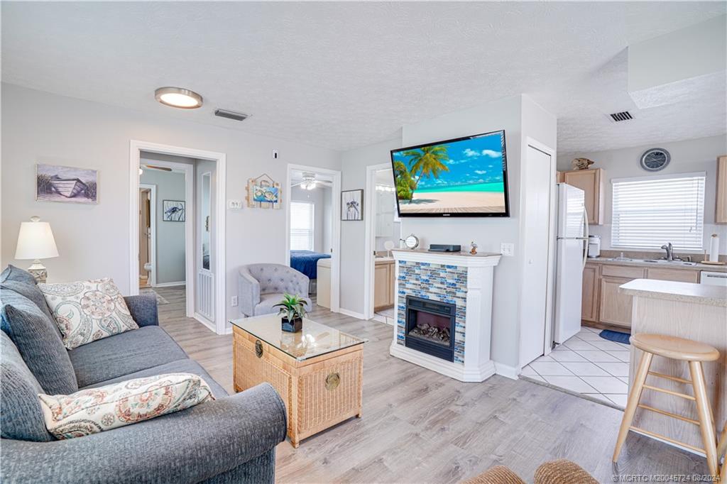 a living room with fireplace furniture and a flat screen tv