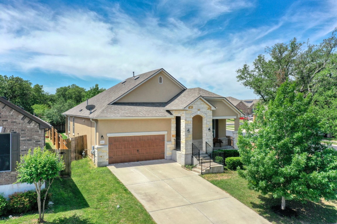 a front view of house with yard and green space