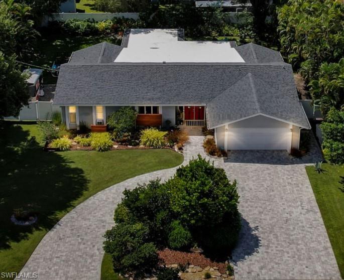 a aerial view of a house with a yard and plants