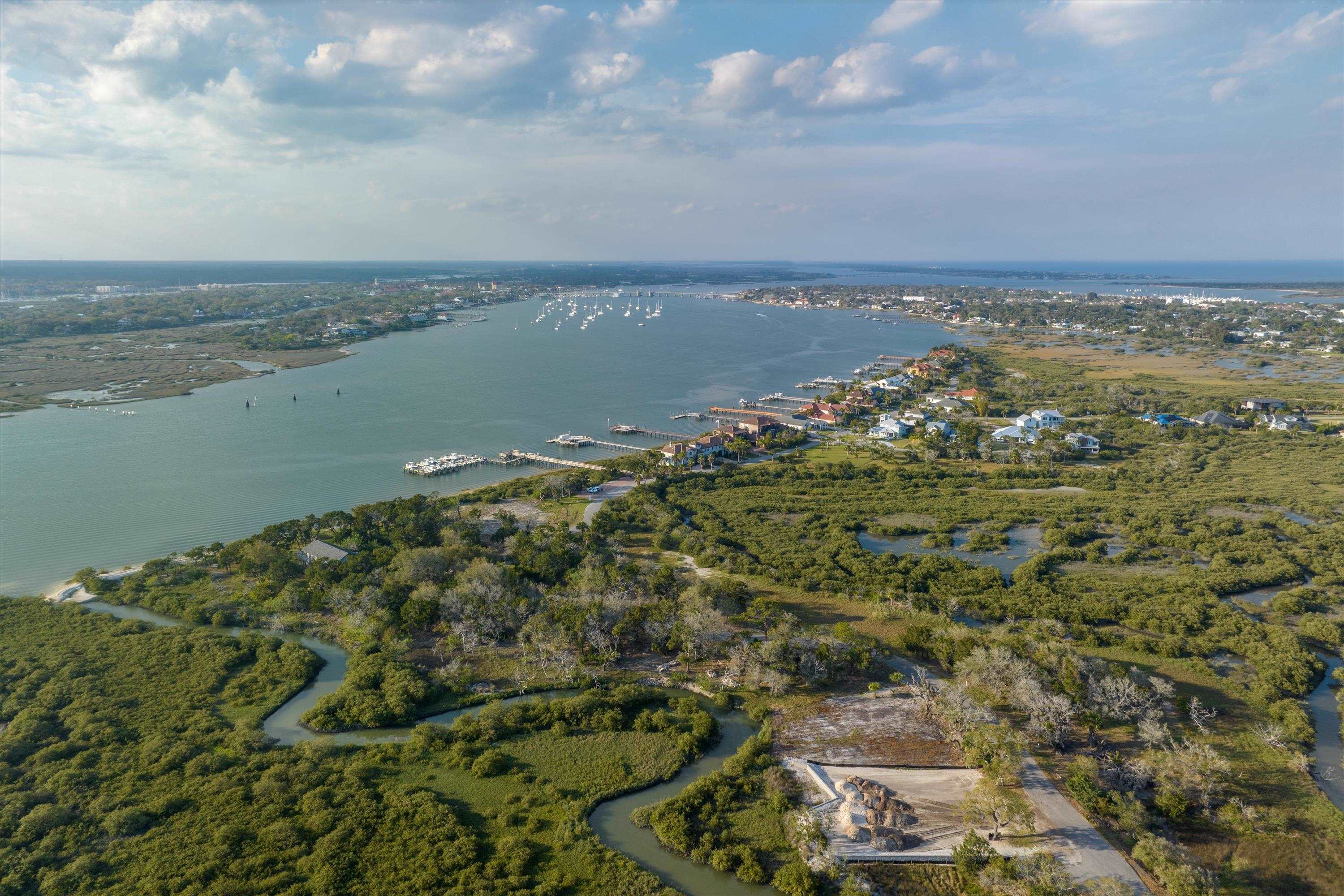 an aerial view of a houses with ocean view