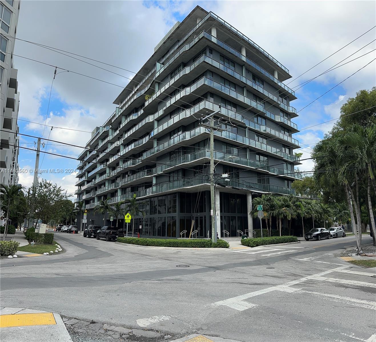 a view of a tall building next to a road