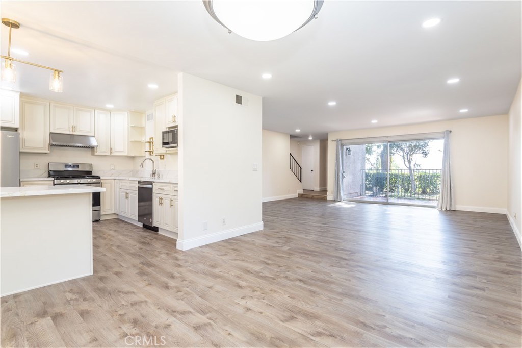 a view of kitchen with cabinets and wooden floor