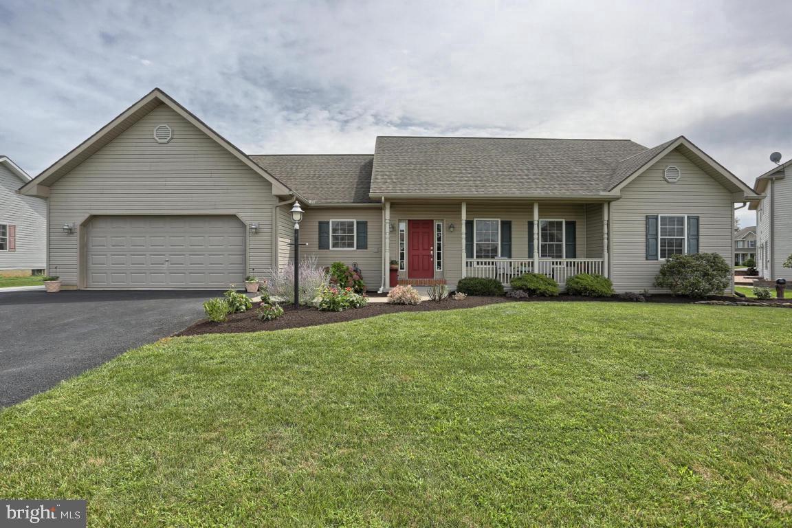 a front view of house with yard and green space