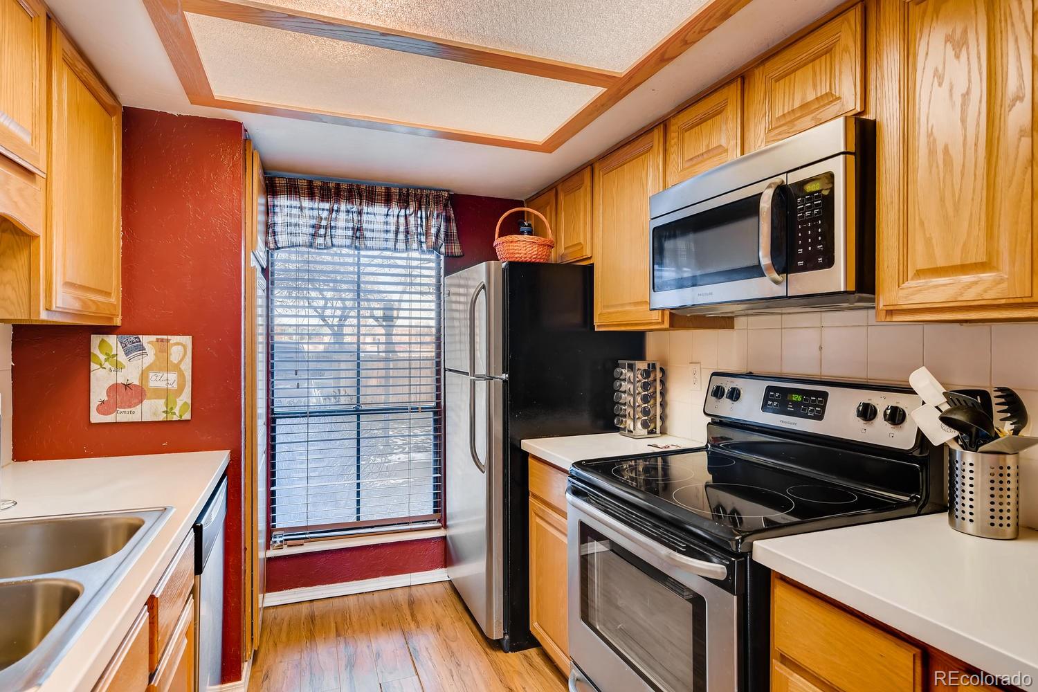 a kitchen with stainless steel appliances granite countertop a stove and a microwave