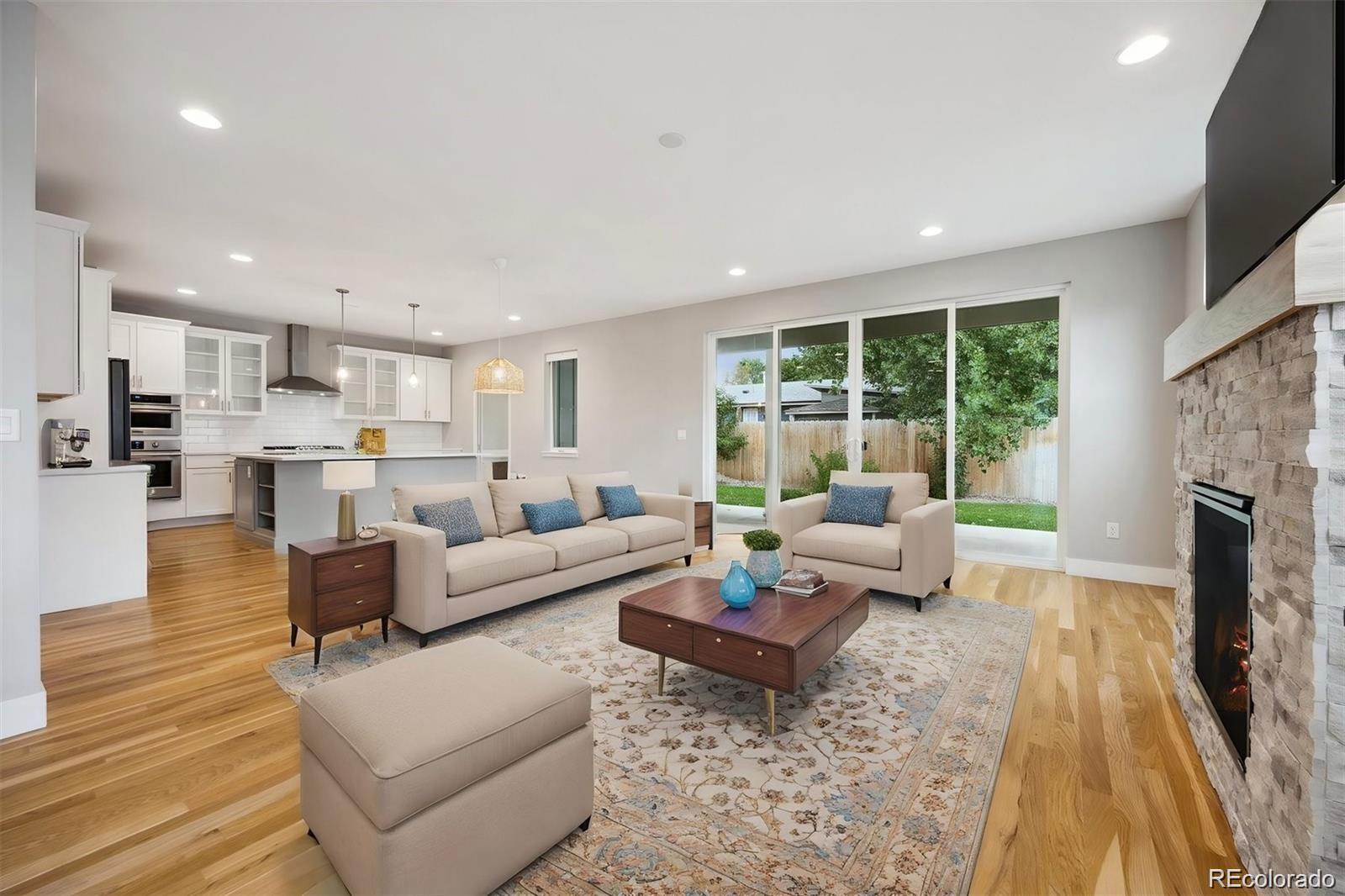 a living room with furniture and a fireplace