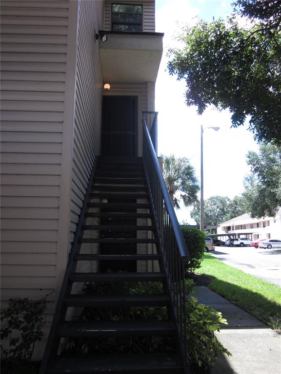 a view of a pathway of a house with a yard