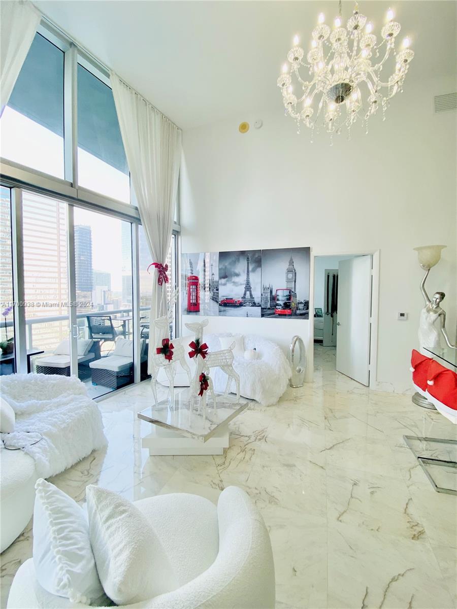 a living room with furniture and a chandelier