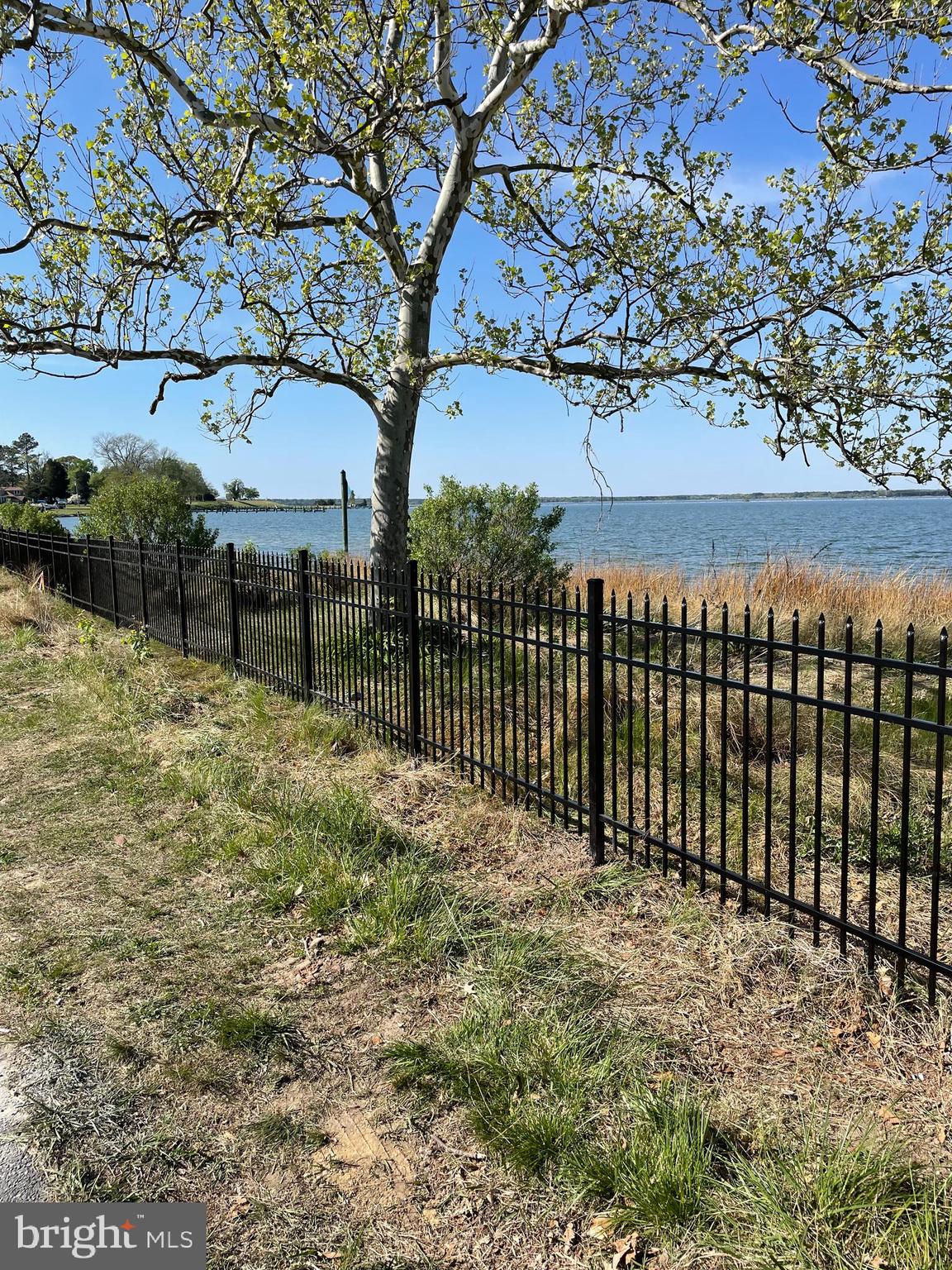 a view of a pathway with a wrought fence