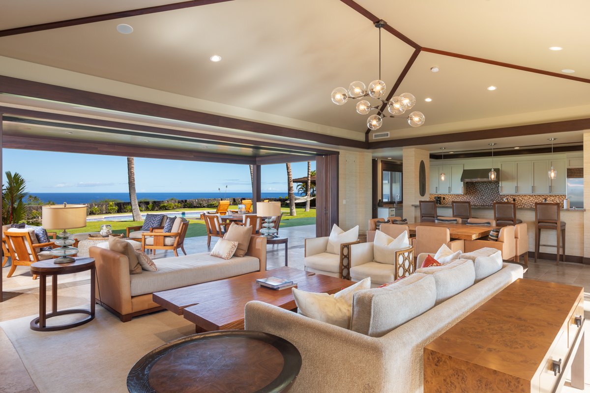 a living room with lots of furniture and a large window