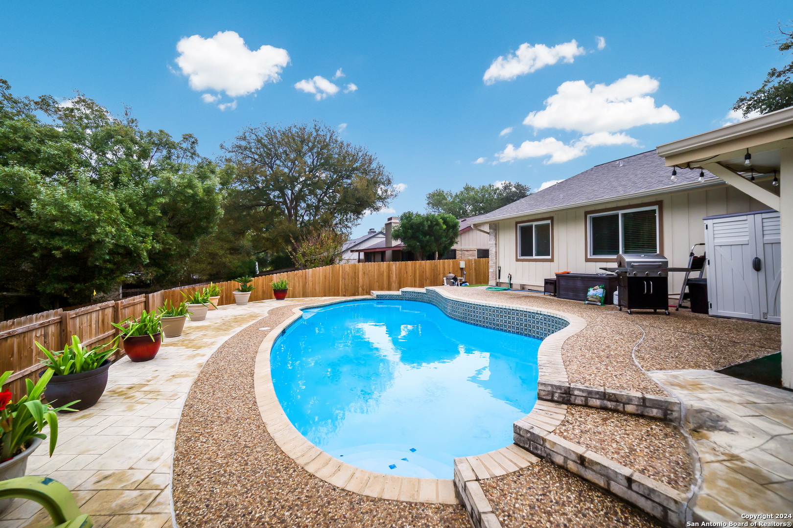 a swimming pool with outdoor seating and yard