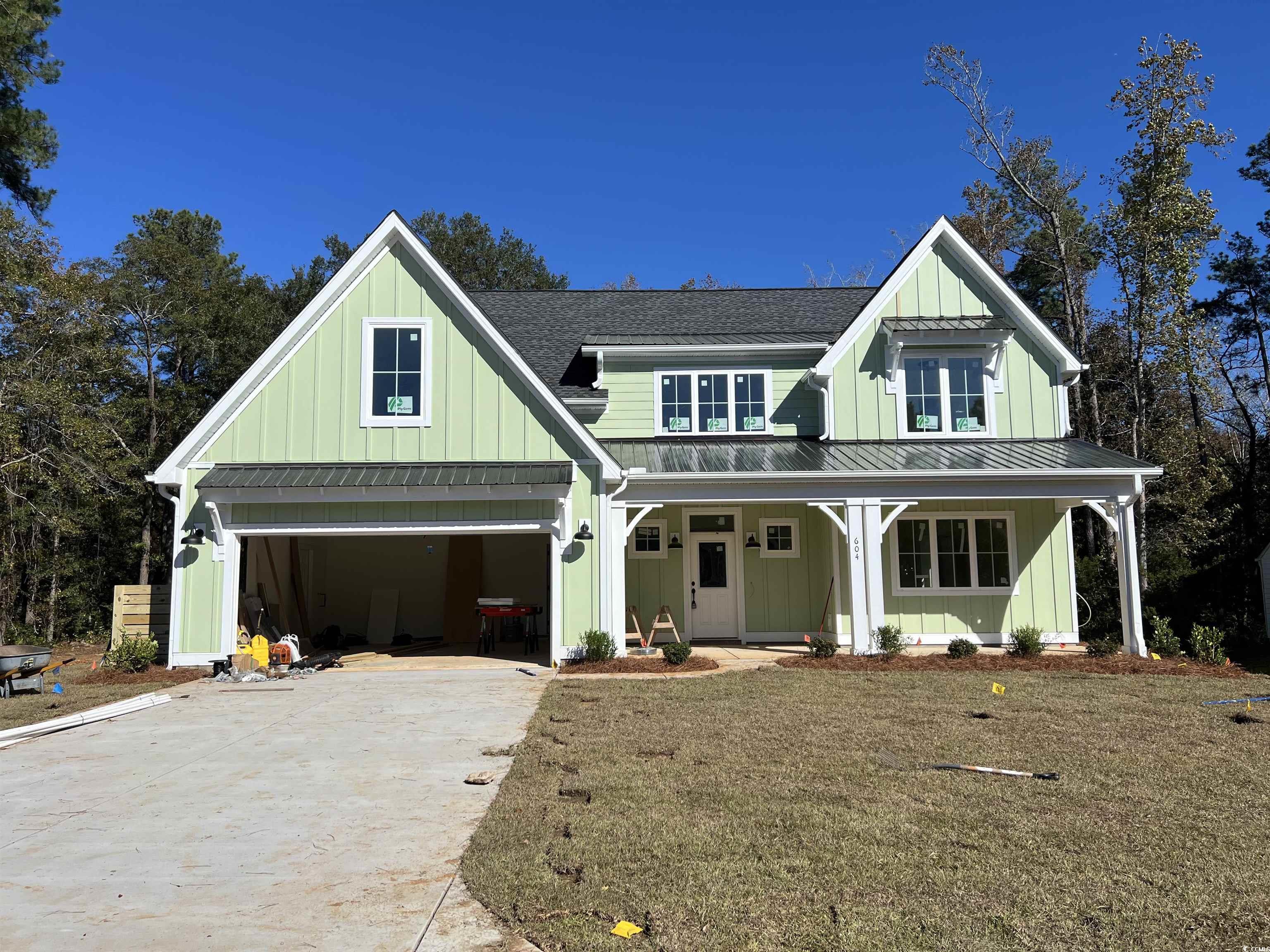 Modern farmhouse style home featuring covered porc