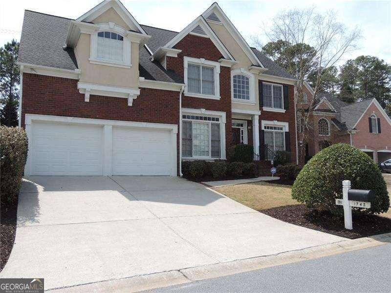 a front view of a house with garage