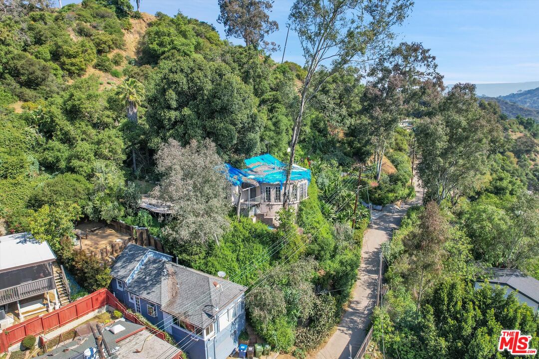 an aerial view of a house with a yard