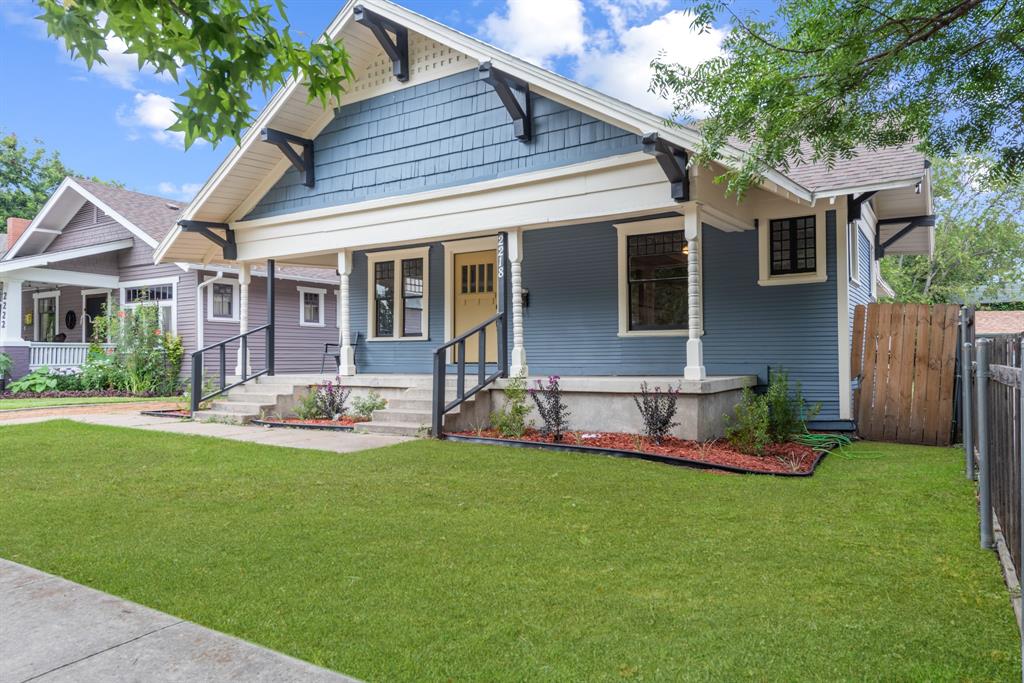 a view of a house with a yard and sitting area