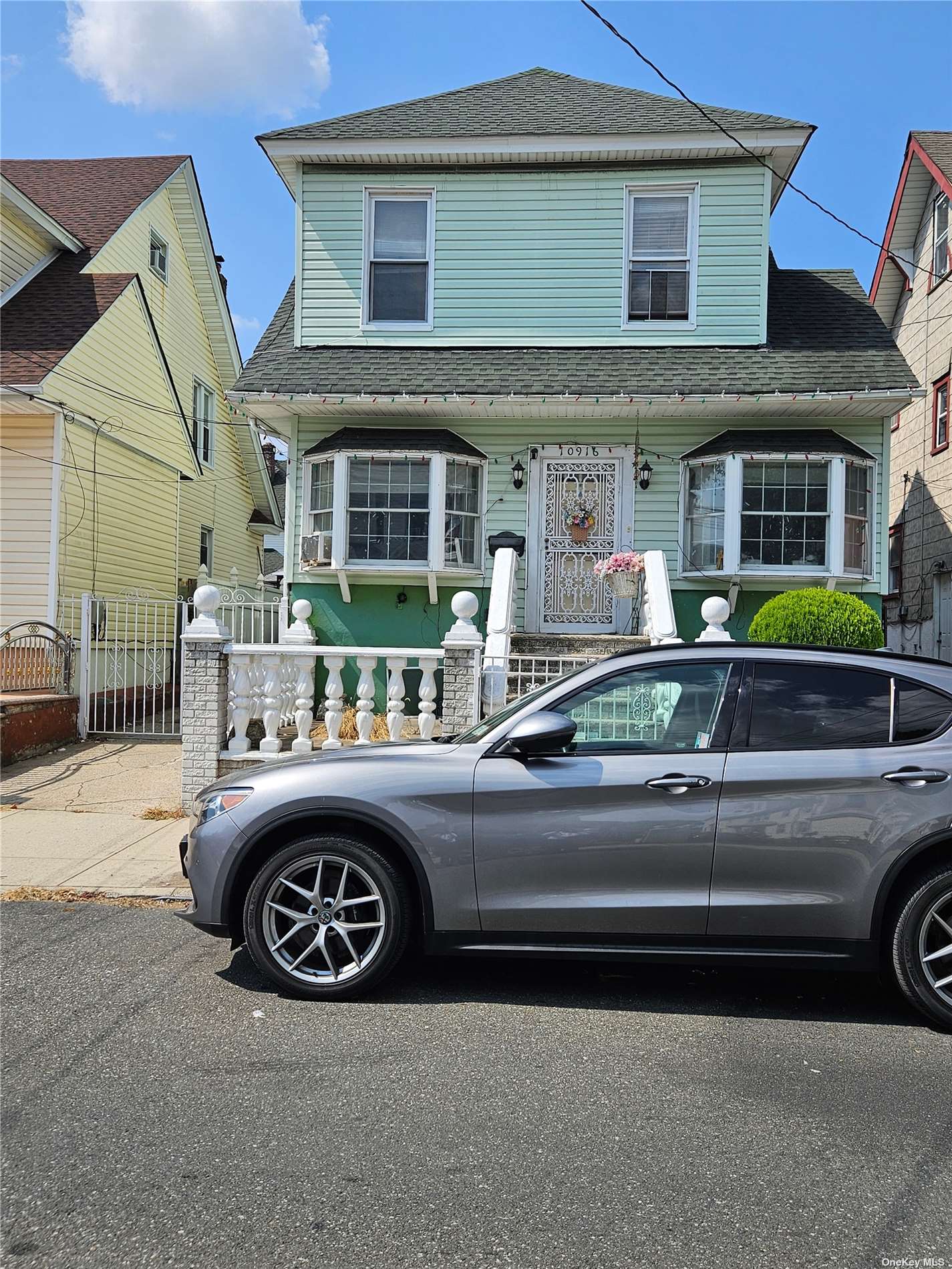 a front view of a house with parking space