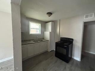 a kitchen with a refrigerator and a stove