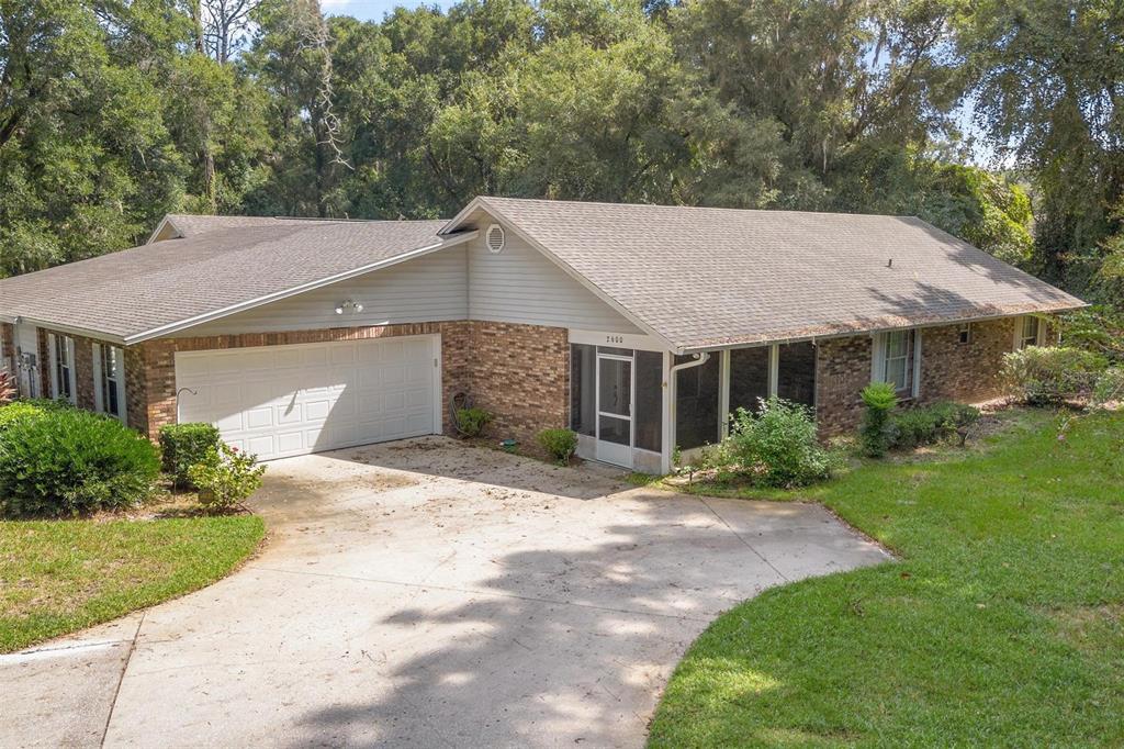 a aerial view of a house with a yard and garage