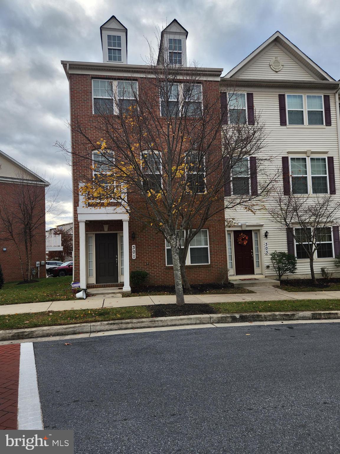 a front view of a house with a street