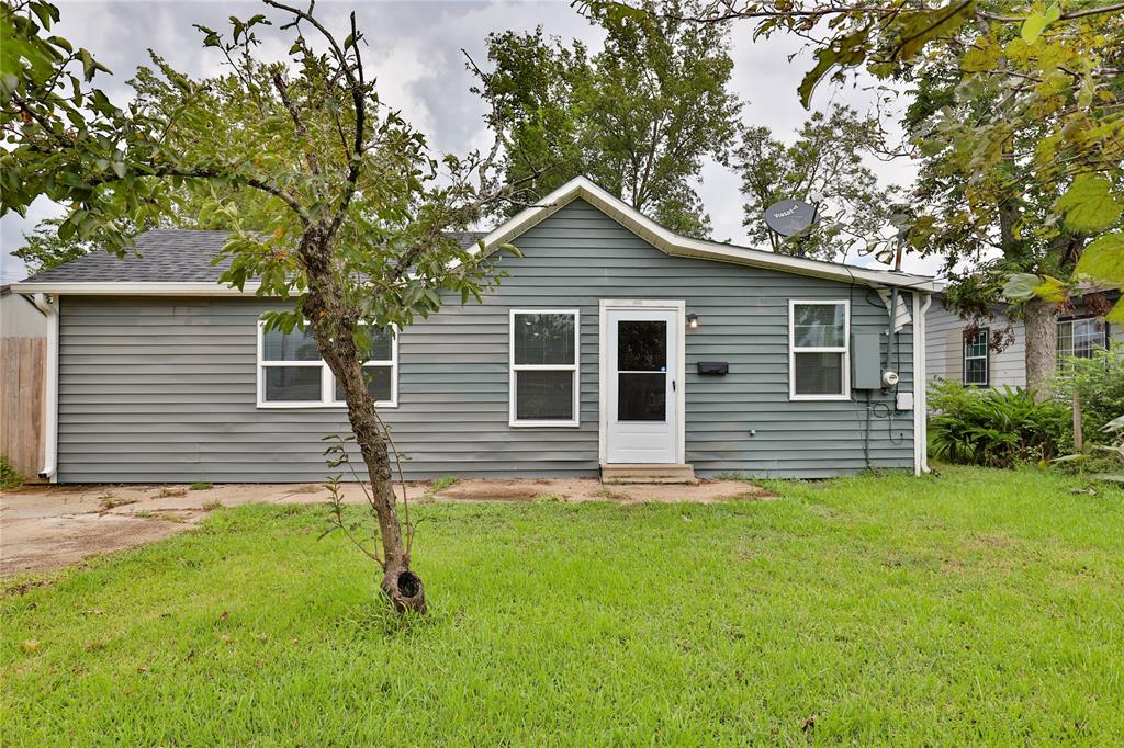 a house that has a tree in front of the house