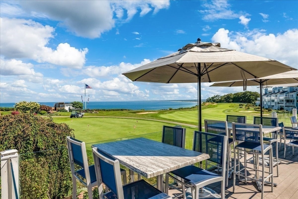 a view of an outdoor space with furniture and umbrella