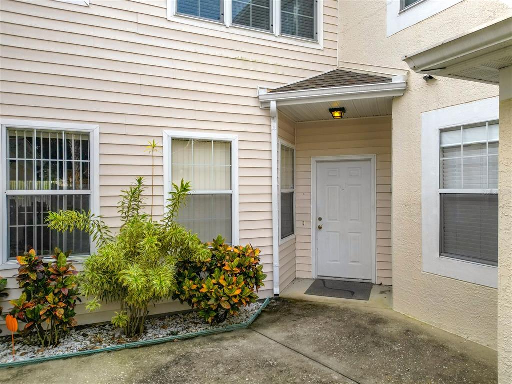 a view of a house with potted plants