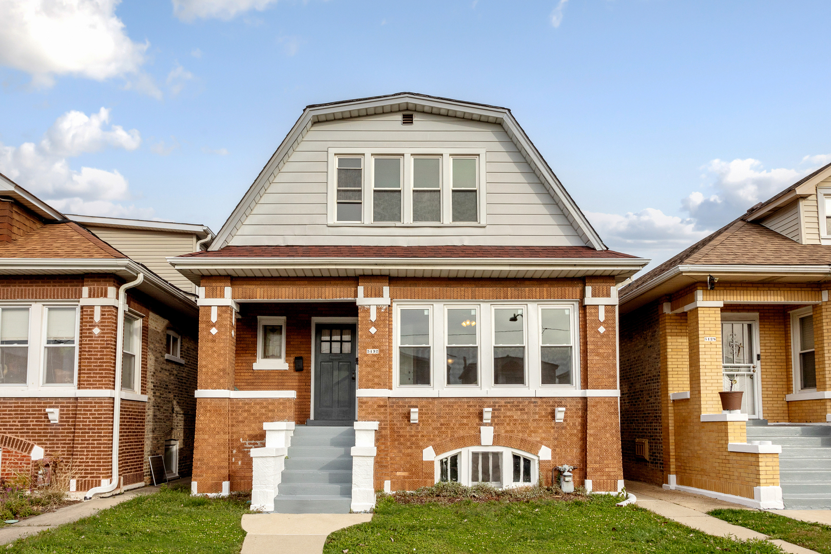 a front view of a house with a yard