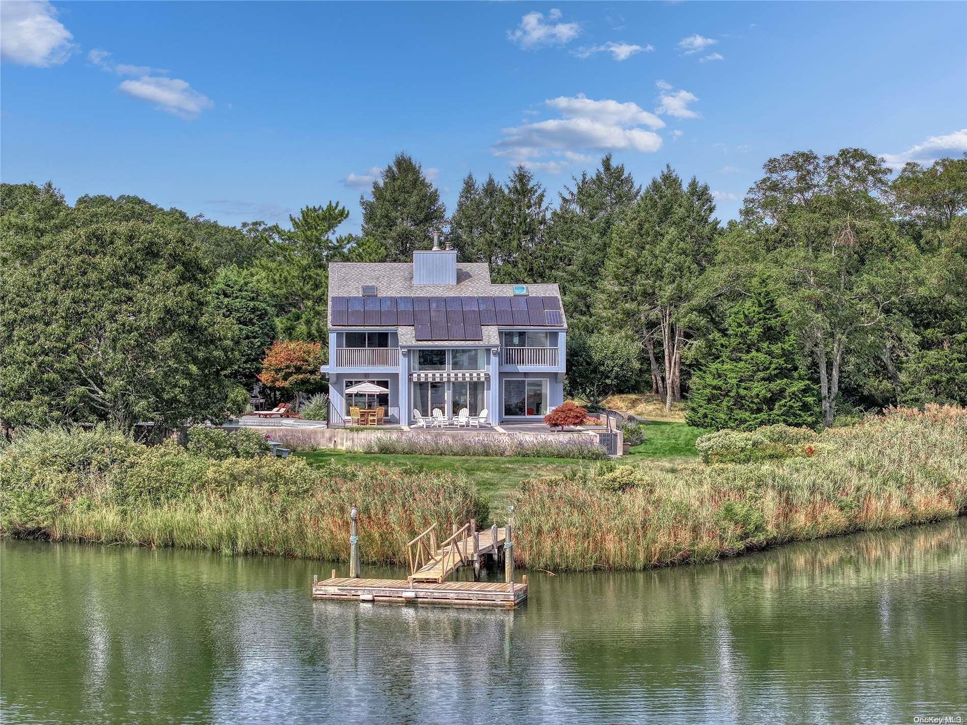 a view of a lake with a house in the background