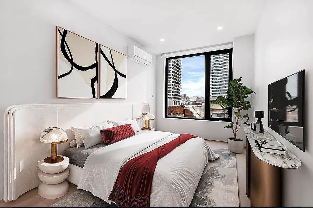 a bedroom with a large bed and a flat tv screen on dresser