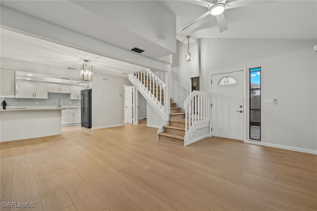 a view of a livingroom with white cabinets and entryway