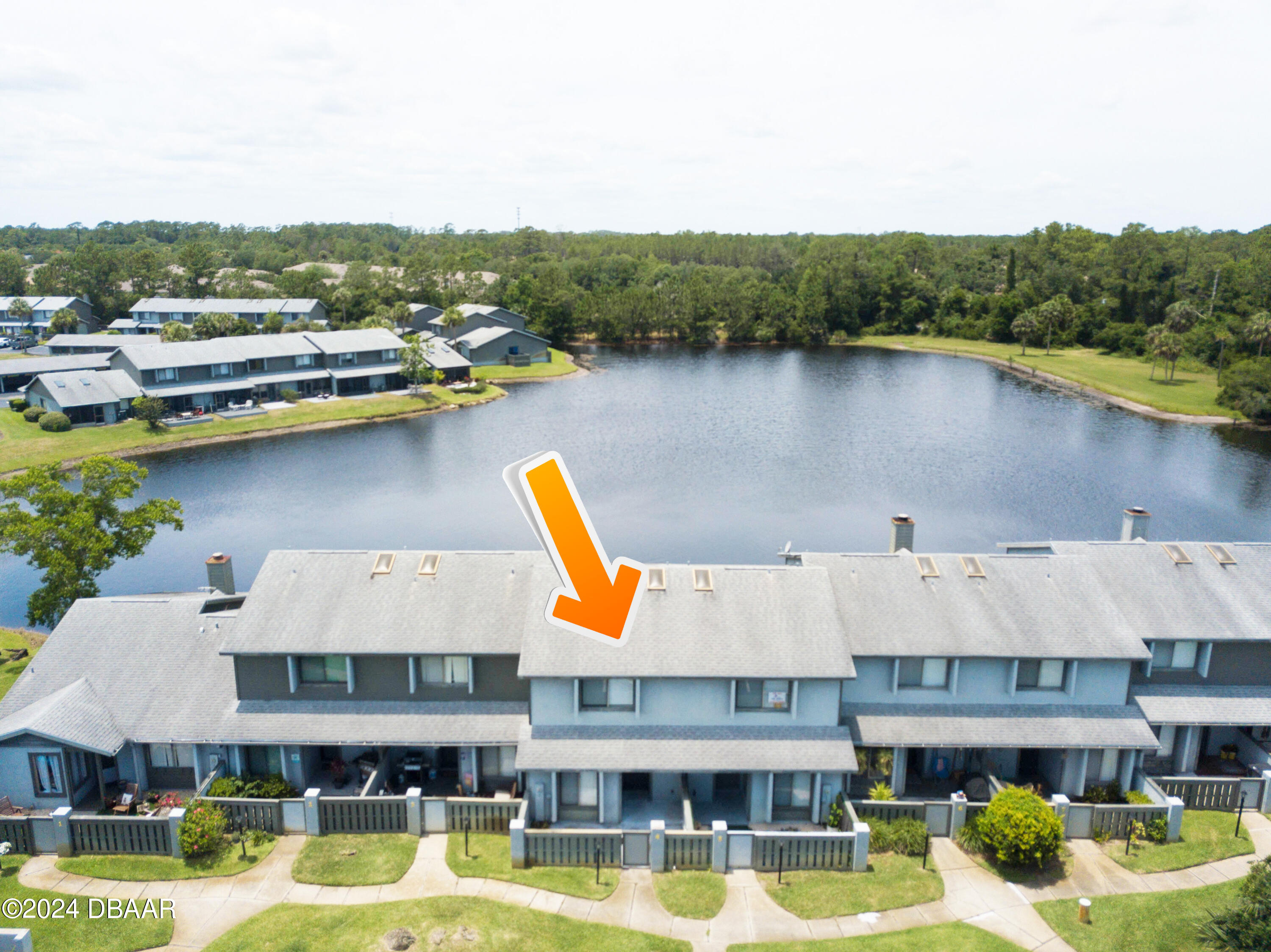 a aerial view of a house with swimming pool and lake view