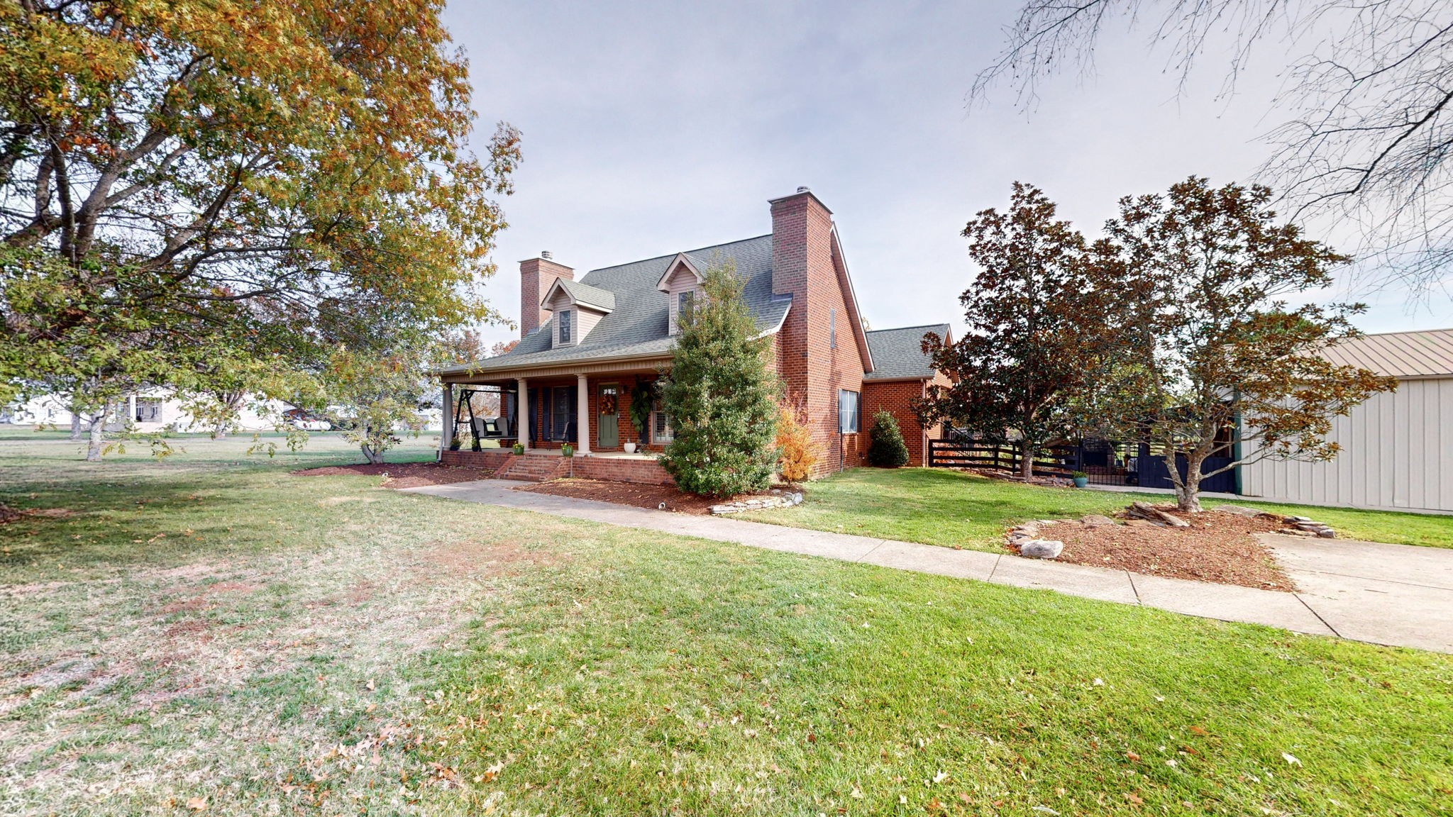 a view of house with outdoor space and swimming pool