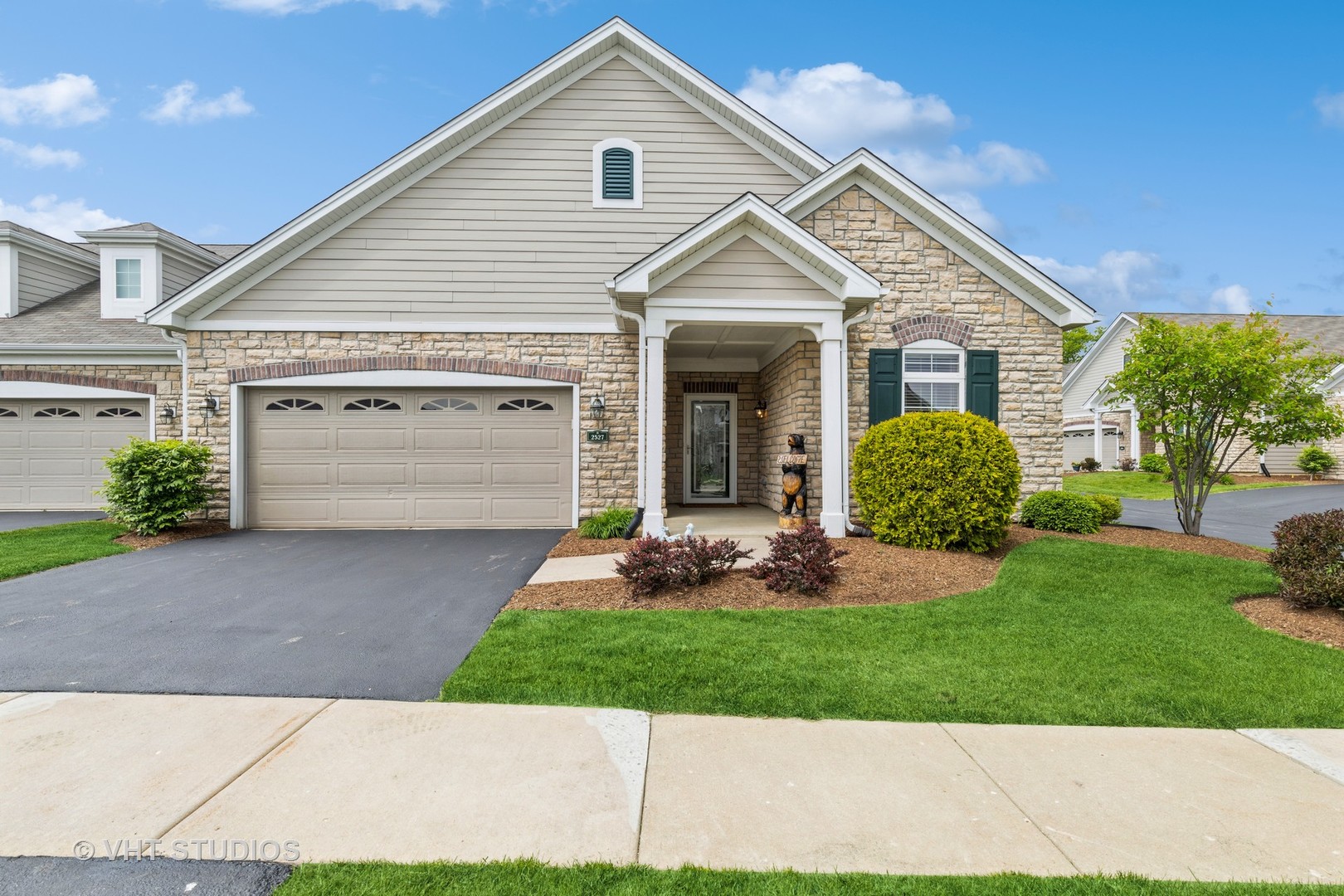 a front view of a house with a yard and garage