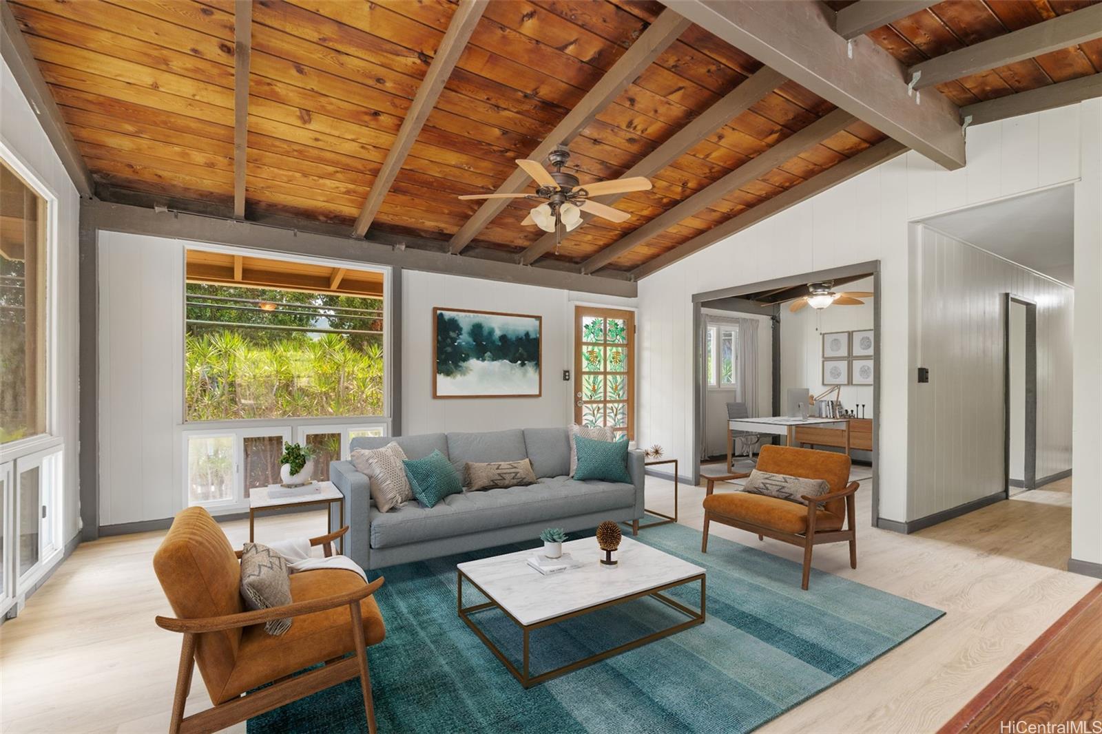 a living room with furniture a rug and a large window