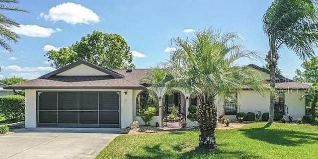 a house with palm tree in front of it