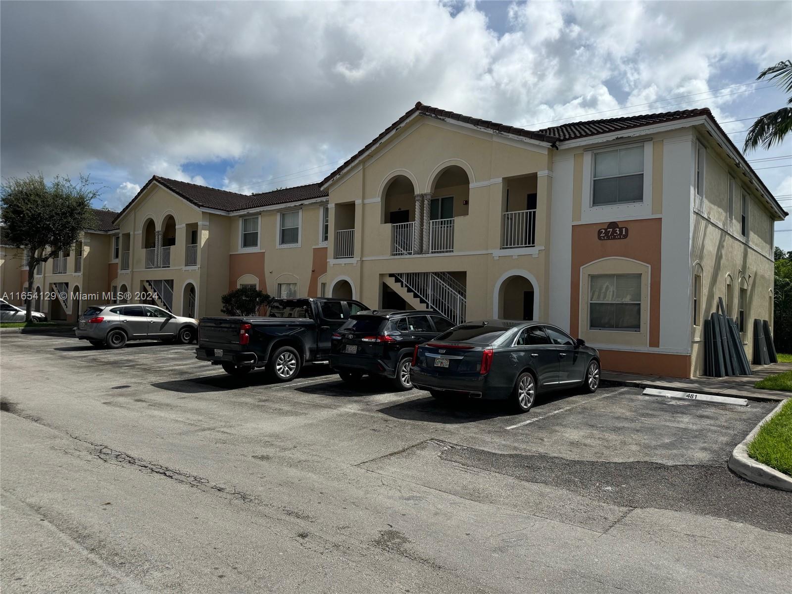 a view of a car park in front of a house