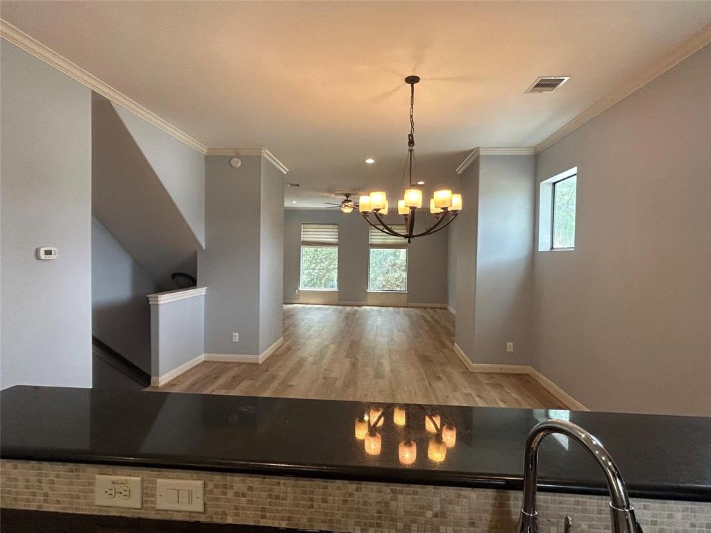 a view of a livingroom with furniture wooden floor and chandelier