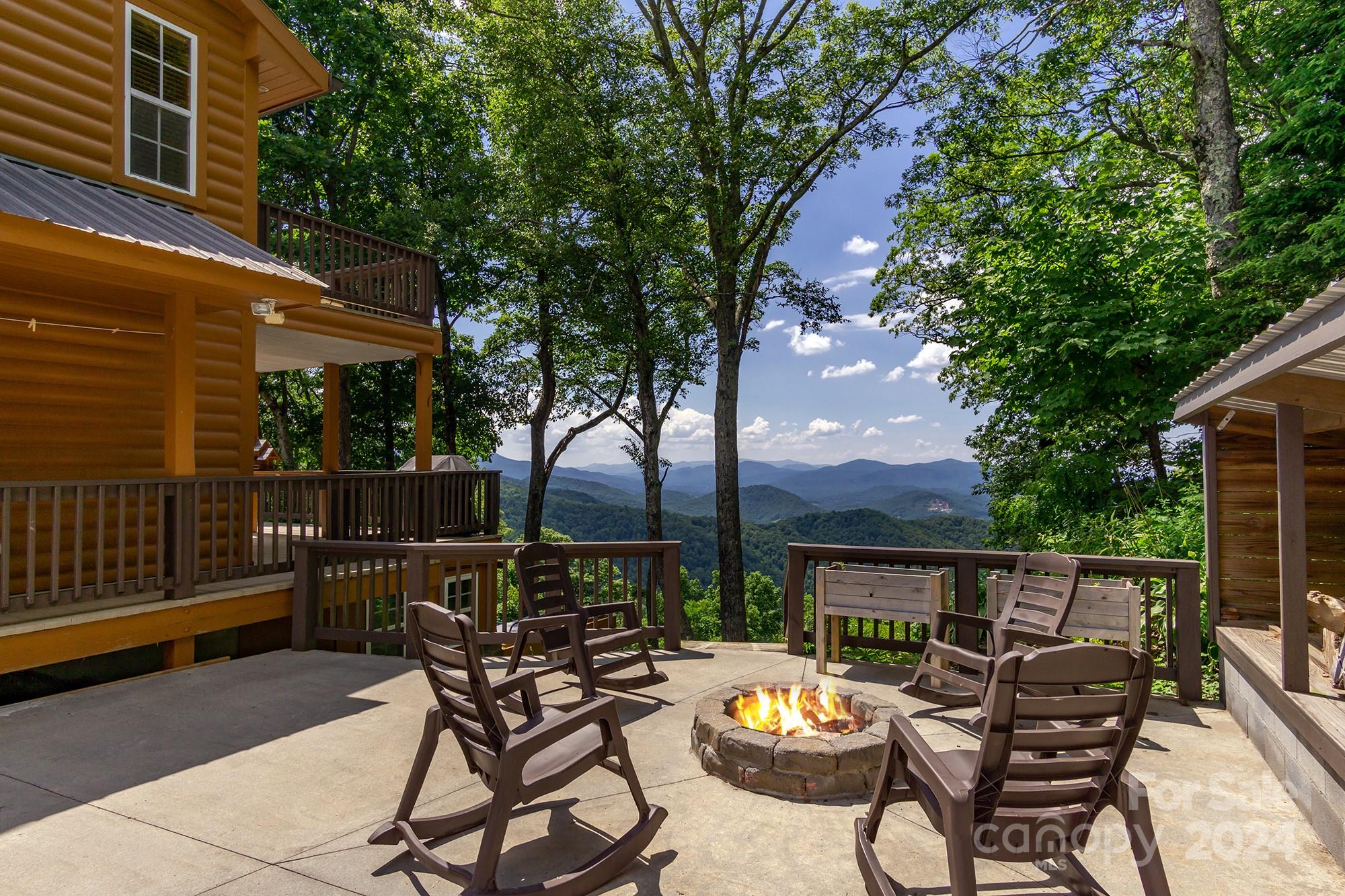 a view of a patio with couches chairs and a wooden floor