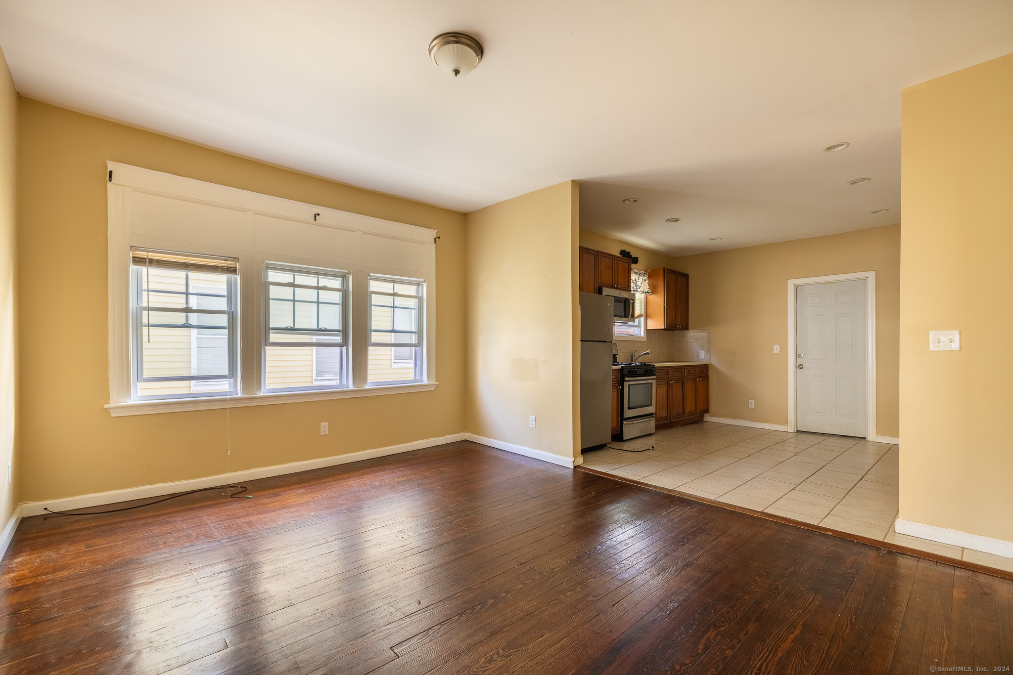 a view of wooden floor and windows in a room