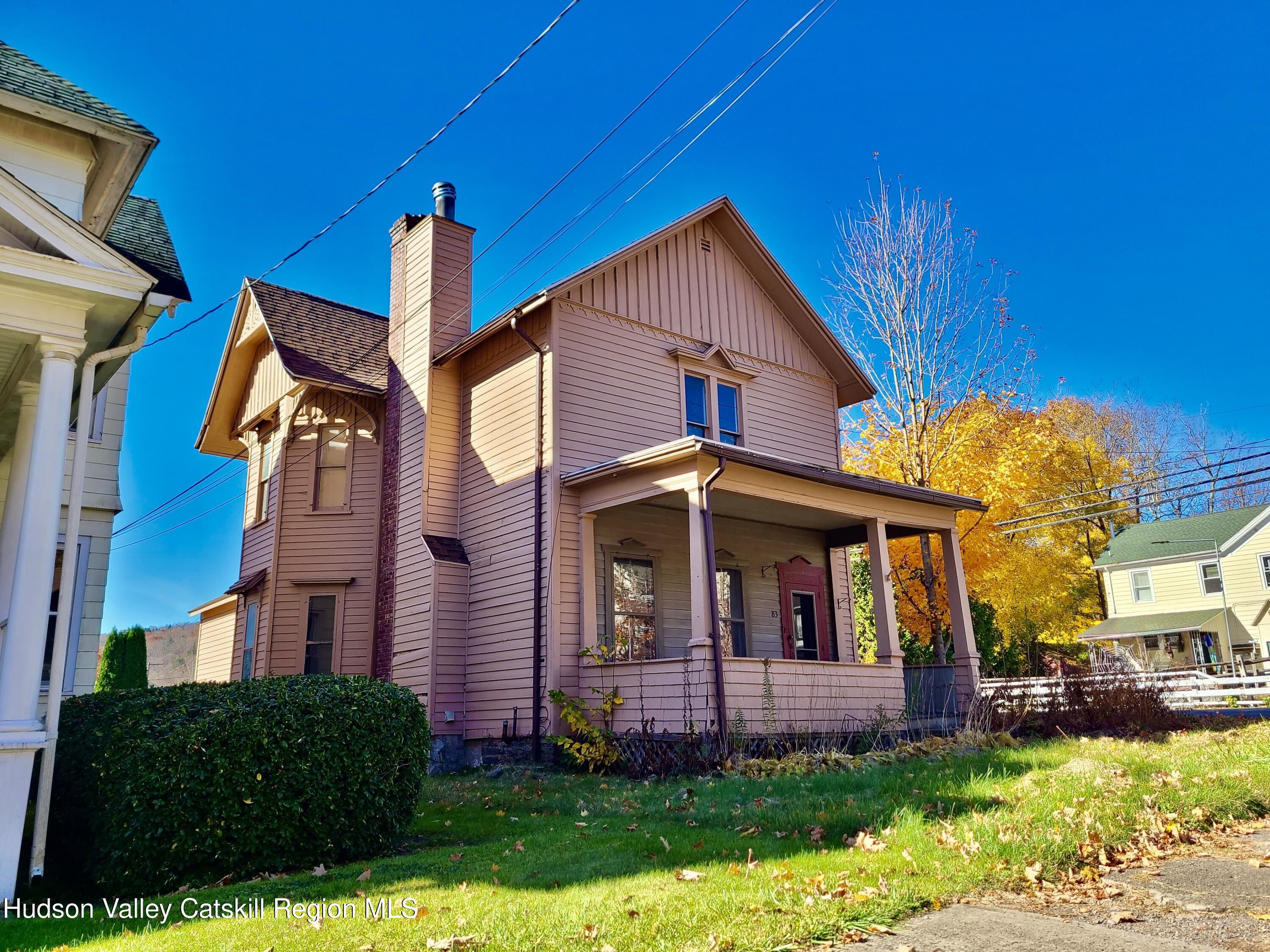 a view of a brick house with a yard