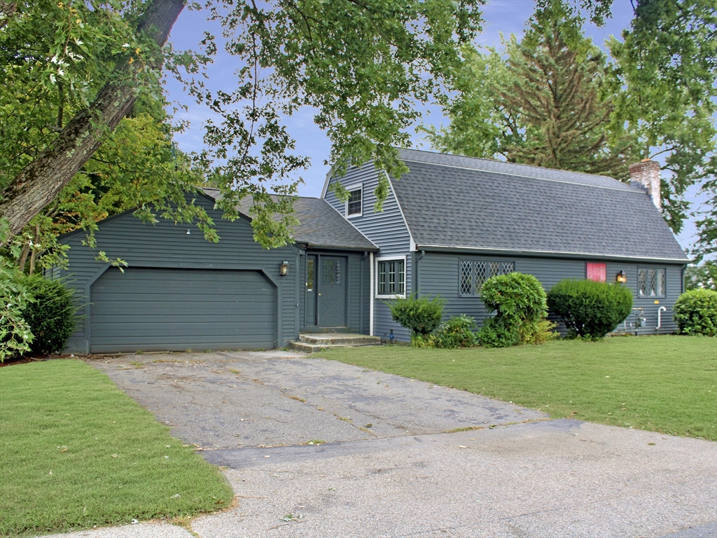 a front view of a house with a yard and a garage