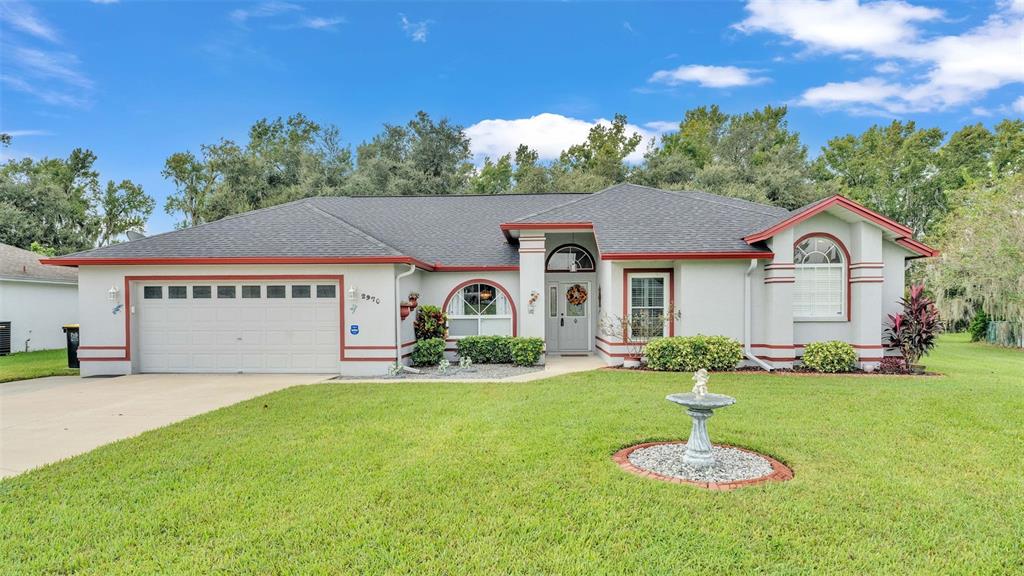 a front view of a house with a yard and garage