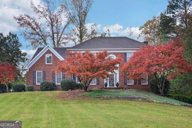 a front view of house with yard and trees